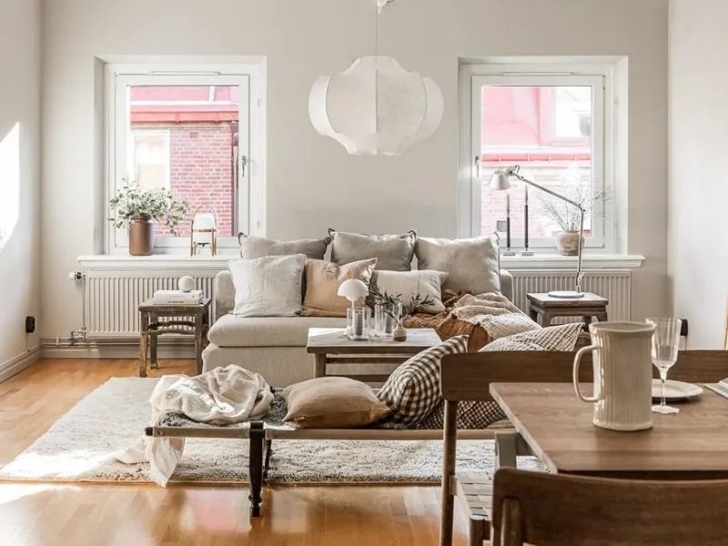 Bianco-legno-crema con dettagli vintage per il soggiorno ideato dallo studio Alvhem Mäkleri & Interiör