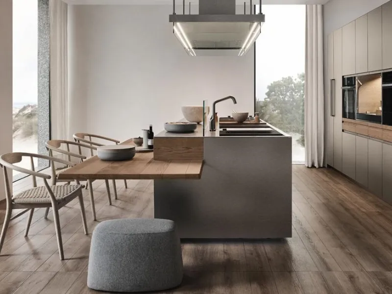 Essenziale l’isola in acciaio con tavolo in legno per Convivium by Arclinea